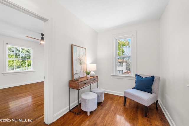 living area featuring wood finished floors and baseboards