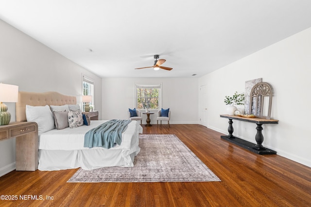 bedroom with a ceiling fan, baseboards, and wood finished floors