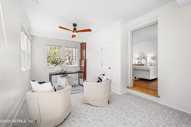living area with baseboards and crown molding