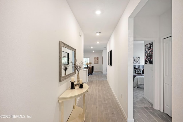 hallway with recessed lighting, baseboards, and wood tiled floor