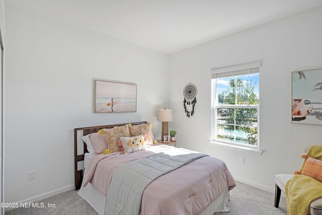 bedroom with baseboards and carpet floors