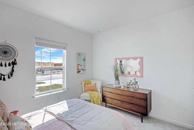 bedroom with baseboards and carpet