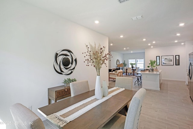 dining space with recessed lighting, visible vents, baseboards, and light wood-style floors