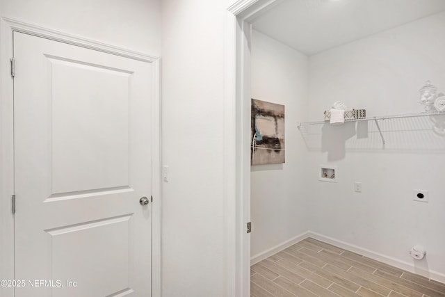 laundry area with hookup for a washing machine, baseboards, hookup for an electric dryer, wood finish floors, and laundry area