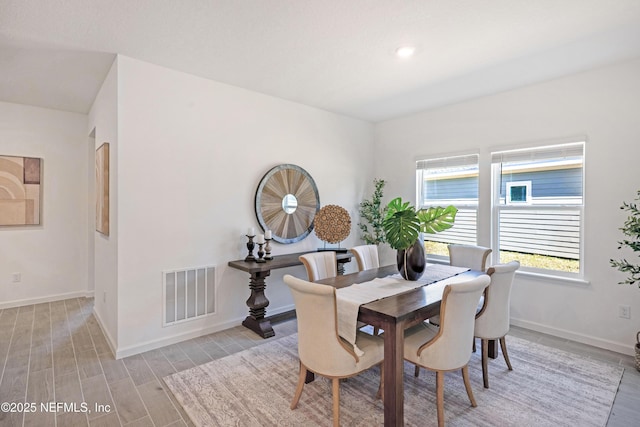 dining area featuring visible vents, baseboards, and light wood-style flooring