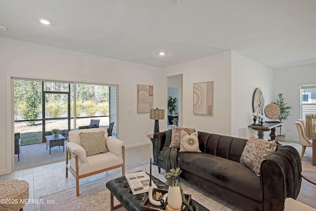 living area with recessed lighting, light wood-type flooring, and baseboards