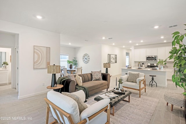 living room with baseboards, recessed lighting, visible vents, and wood tiled floor