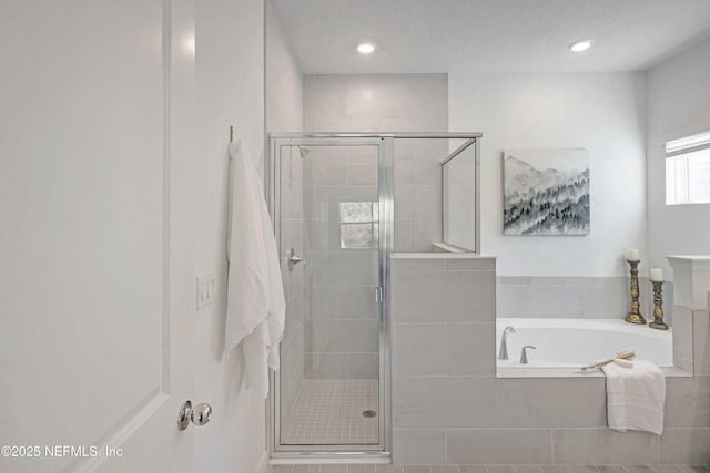 bathroom with a garden tub, recessed lighting, and a stall shower