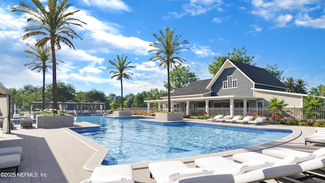 pool with a patio area, fence, and a pergola