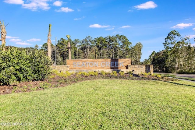 community / neighborhood sign with a yard