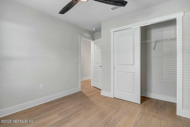 unfurnished bedroom with a closet, visible vents, light wood-style floors, ceiling fan, and baseboards