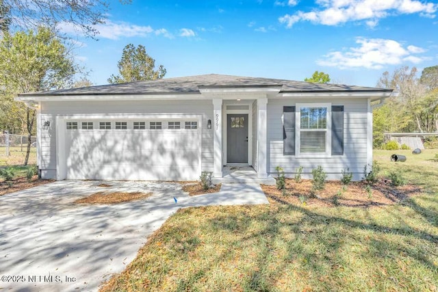 view of front of home featuring a garage, driveway, and a front yard