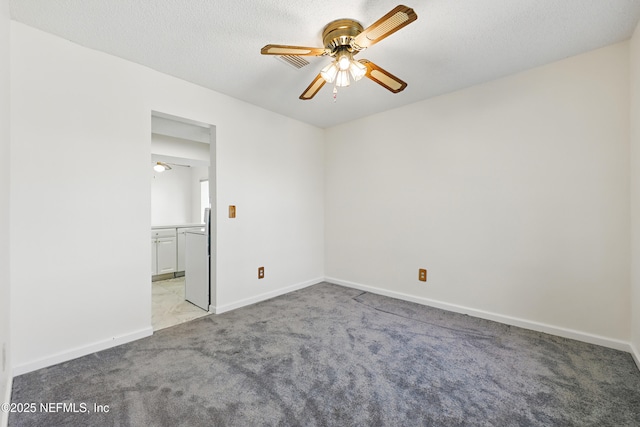 unfurnished room with visible vents, baseboards, ceiling fan, a textured ceiling, and light colored carpet