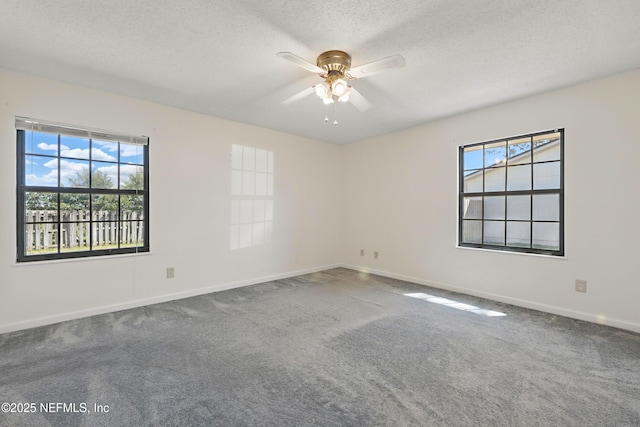 empty room with baseboards, a textured ceiling, a ceiling fan, and carpet floors