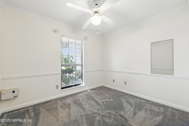 spare room with ceiling fan, baseboards, carpet floors, and ornamental molding