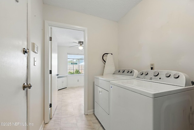 laundry area with a ceiling fan, baseboards, laundry area, a textured ceiling, and washer and clothes dryer