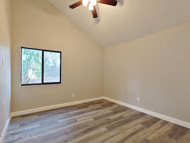 empty room featuring high vaulted ceiling, wood finished floors, a ceiling fan, and baseboards