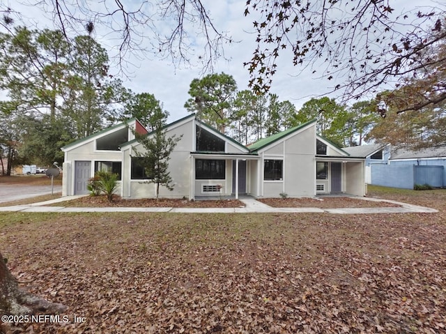 mid-century home with stucco siding