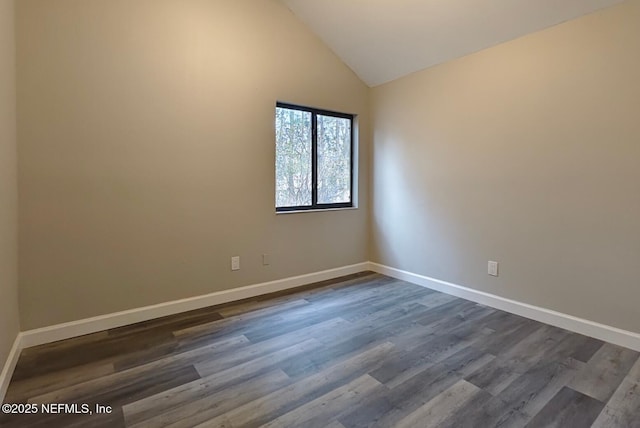 unfurnished room with dark wood-style floors, baseboards, and high vaulted ceiling