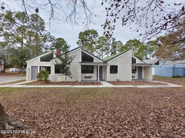 mid-century modern home with stucco siding