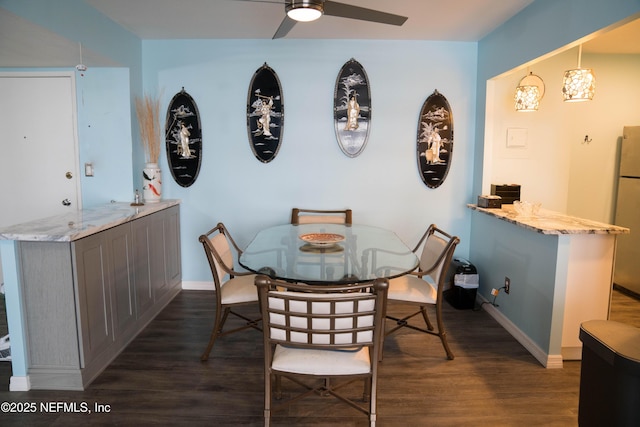 dining room with baseboards, a ceiling fan, and dark wood-style flooring