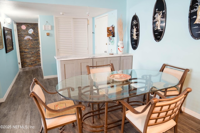 dining area featuring wood finished floors and baseboards