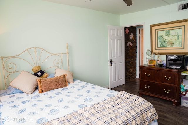 bedroom with ceiling fan, visible vents, and dark wood-type flooring