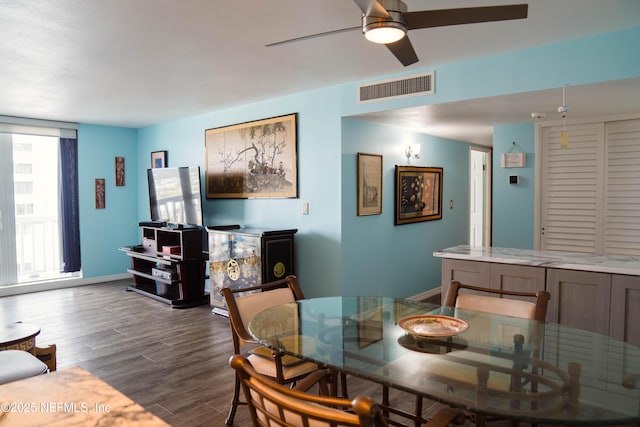 dining space featuring ceiling fan, dark wood-style flooring, visible vents, and baseboards