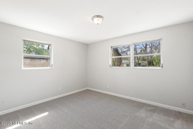 empty room with carpet flooring and baseboards