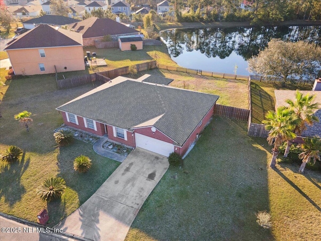 drone / aerial view with a water view and a residential view