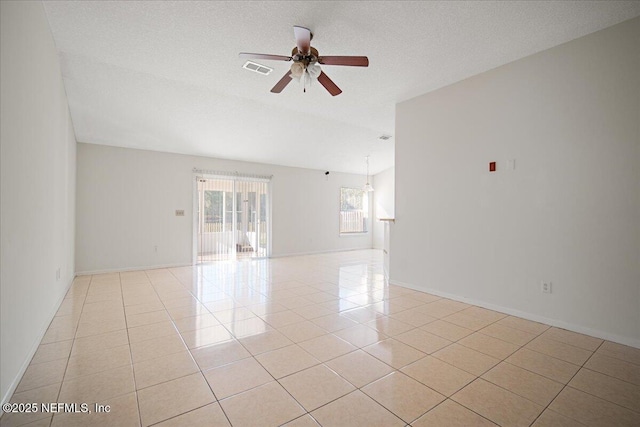 unfurnished room with light tile patterned floors, ceiling fan, visible vents, and a textured ceiling