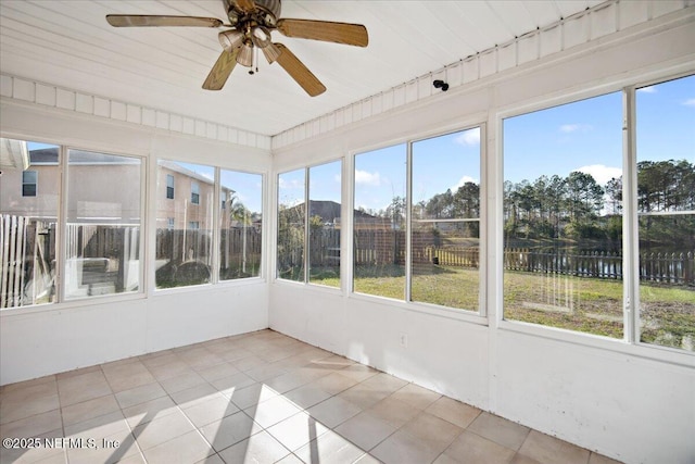 unfurnished sunroom featuring ceiling fan