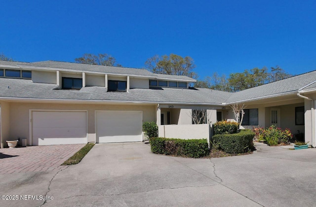 view of property exterior featuring driveway, a garage, and stucco siding