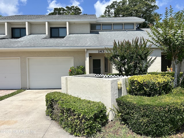 143 La Pasada Cir W, Ponte Vedra Beach, FL 32082 - view of front facade featuring concrete driveway, stucco siding, and a shingled roof