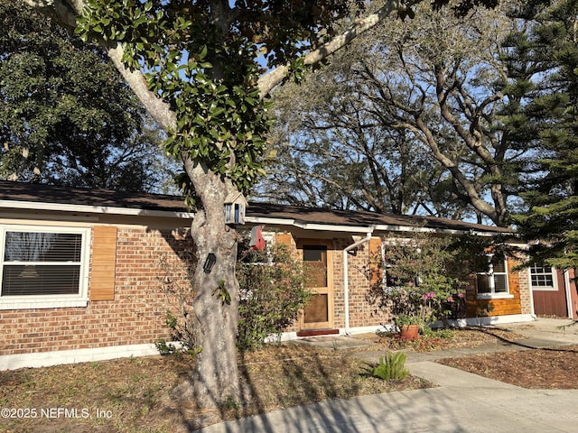 obstructed view of property featuring brick siding