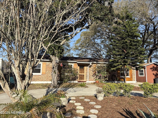 obstructed view of property with brick siding