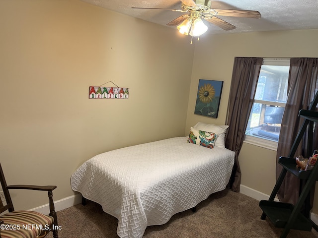 bedroom with baseboards, a textured ceiling, carpet, and a ceiling fan