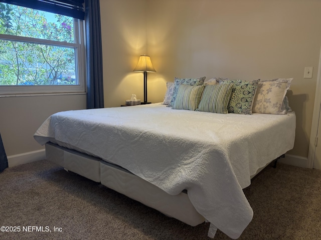 carpeted bedroom featuring baseboards