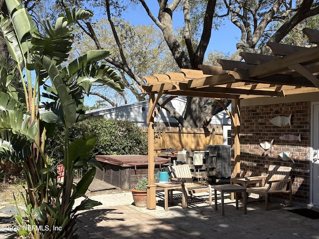 view of patio / terrace featuring fence, a pergola, and a hot tub