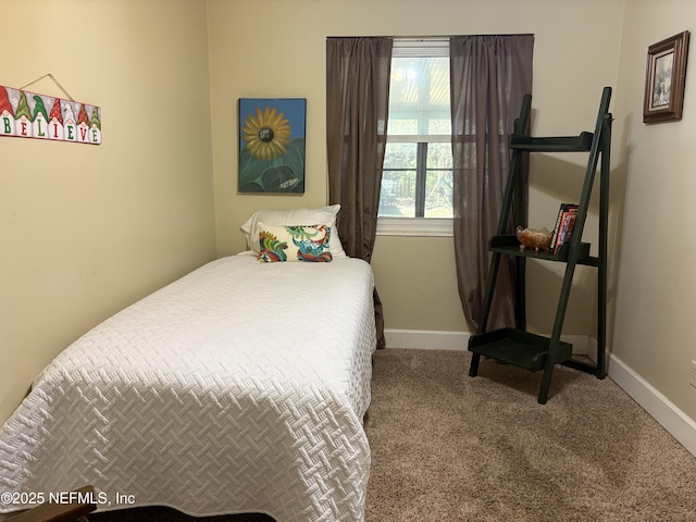 carpeted bedroom featuring baseboards