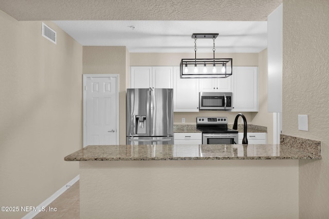 kitchen with stainless steel appliances, light stone counters, visible vents, and white cabinetry