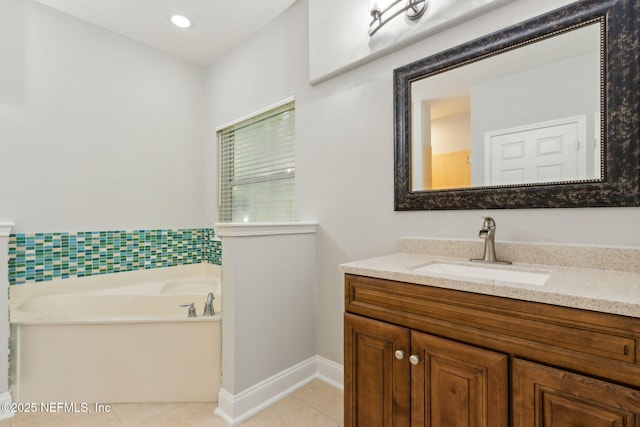 bathroom with tile patterned floors, recessed lighting, baseboards, a bath, and vanity