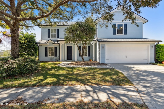 traditional-style house with a front yard, an attached garage, and driveway