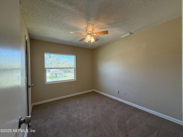 carpeted empty room featuring baseboards, visible vents, ceiling fan, and a textured ceiling