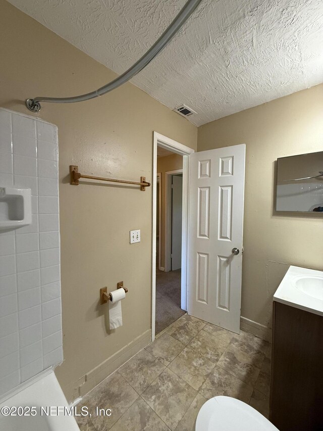 full bathroom with a shower, visible vents, vanity, and a textured ceiling