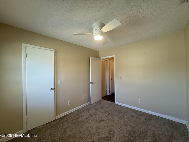 unfurnished bedroom featuring carpet floors, visible vents, a ceiling fan, a textured ceiling, and baseboards