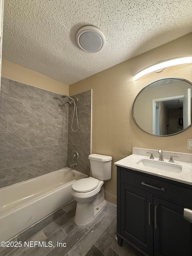 full bathroom with a textured ceiling, shower / tub combination, toilet, vanity, and wood tiled floor