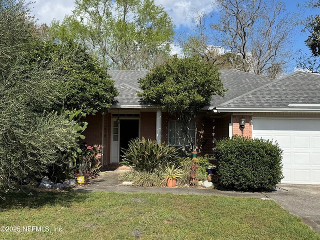 view of front facade featuring brick siding, an attached garage, and a shingled roof