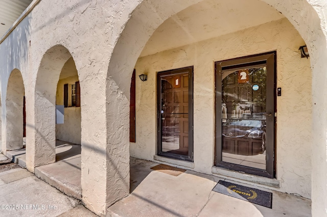 doorway to property with stucco siding