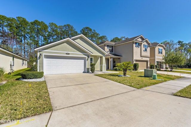 view of front of home featuring a garage, driveway, and a front yard